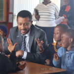 Belay Addise Eastern and Southern Africa Regional Manager for the Global Partnership for Education (GPE) experiancing first hand learners in the reception class at Sion Primary School (1)